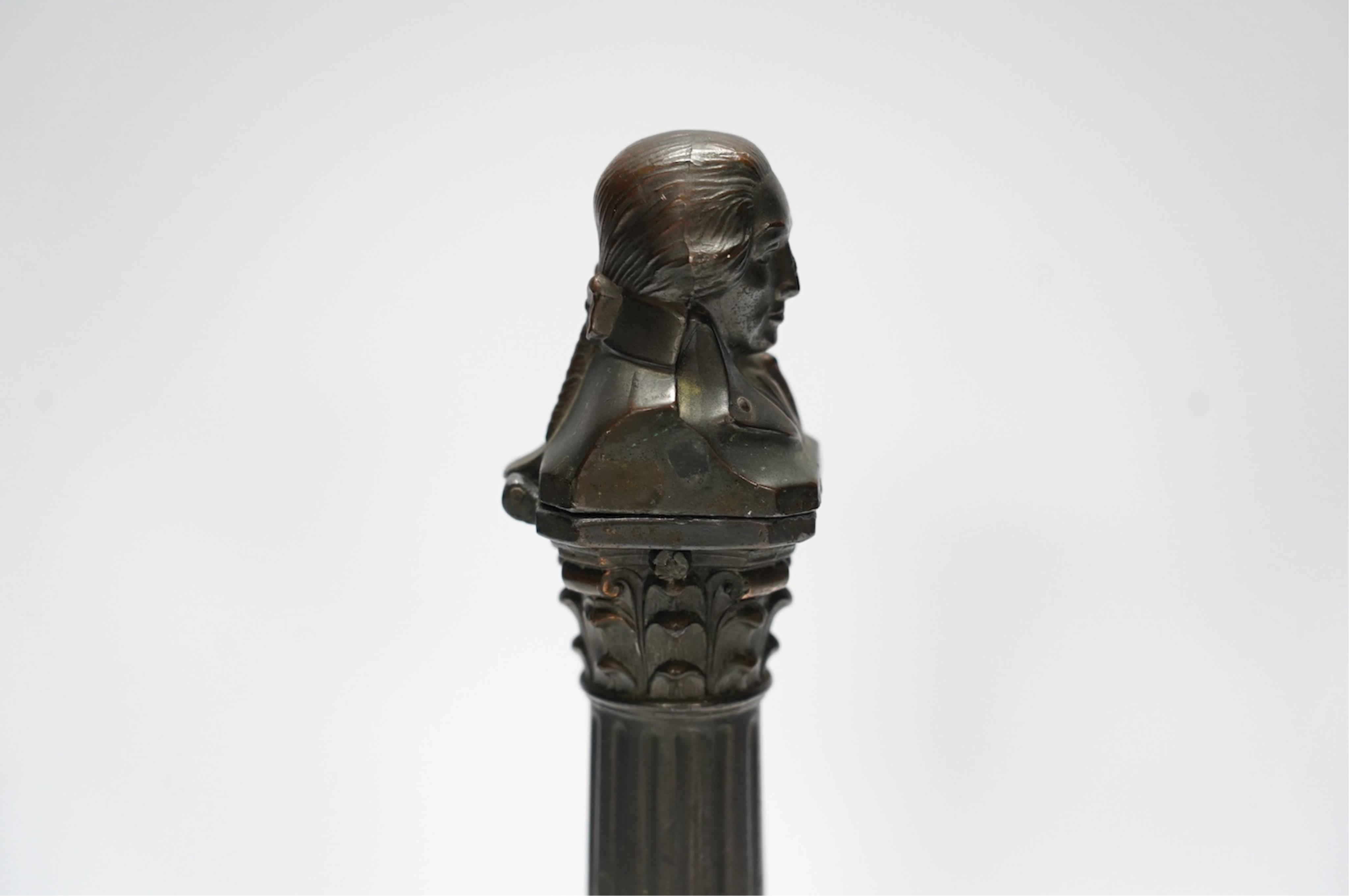 A spelter bust of Lord Nelson on a column table lighter, 25cm high. Condition - poor to fair, hinge broken, untested